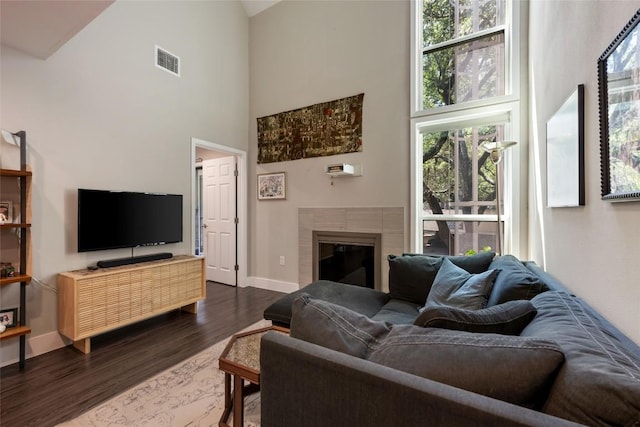 935 La Posada Dr Unit 243, Austin, TX 78752 - living area with high vaulted ceiling, dark wood-type flooring, and a fireplace
