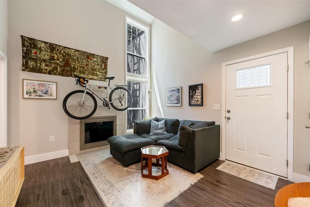 935 La Posada Dr Unit 243, Austin, TX 78752 - living room with dark wood-type flooring, baseboards, recessed lighting, and a fireplace
