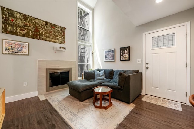 935 La Posada Dr Unit 243, Austin, TX 78752 - living area with wood finished floors, high vaulted ceiling, a fireplace, and recessed lighting