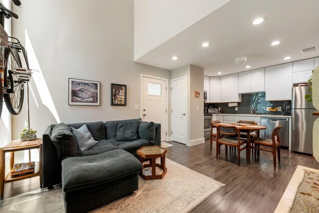 935 La Posada Dr Unit 243, Austin, TX 78752 - living room with recessed lighting and dark wood finished floors