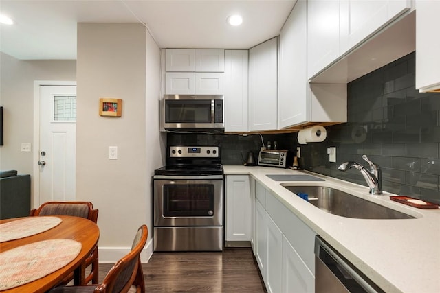 935 La Posada Dr Unit 243, Austin, TX 78752 - kitchen featuring appliances with stainless steel finishes, a sink, light countertops, white cabinets, and recessed lighting