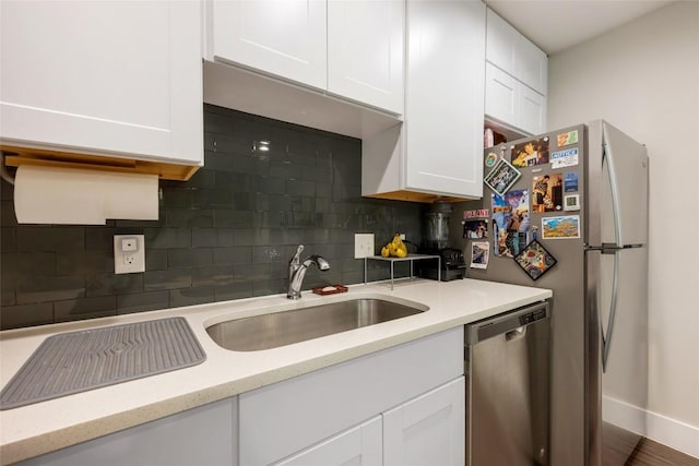 935 La Posada Dr Unit 243, Austin, TX 78752 - kitchen with stainless steel appliances, white cabinetry, and backsplash
