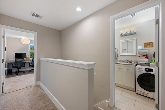 935 La Posada Dr Unit 243, Austin, TX 78752 - hallway with washer / dryer, an upstairs landing, a desk, recessed lighting, and light carpet