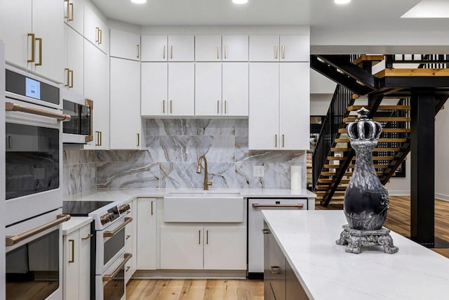 129 Cedar Dr, Horseshoe Bay, TX 78657 - kitchen with a sink, white appliances, light stone countertops, decorative backsplash, and recessed lighting