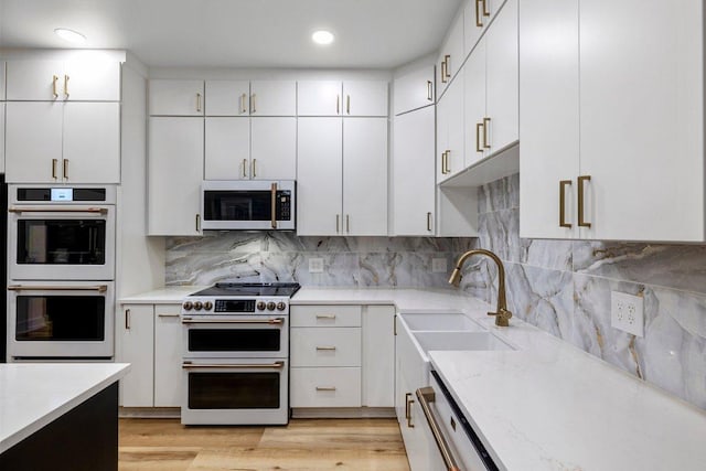 129 Cedar Dr, Horseshoe Bay, TX 78657 - kitchen featuring white appliances, a sink, white cabinets, decorative backsplash, and recessed lighting