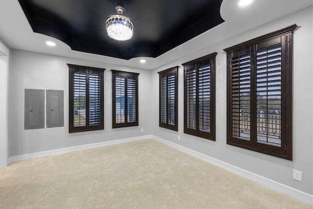 129 Cedar Dr, Horseshoe Bay, TX 78657 - empty room featuring electric panel, a tray ceiling, carpet floors, baseboards, and recessed lighting