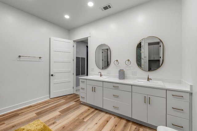 129 Cedar Dr, Horseshoe Bay, TX 78657 - full bath featuring double vanity, wood finished floors, baseboards, and recessed lighting
