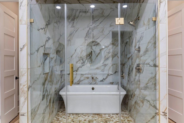 129 Cedar Dr, Horseshoe Bay, TX 78657 - full bath with a freestanding tub, a marble finish shower, and tile walls