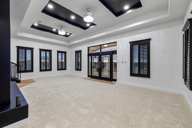 129 Cedar Dr, Horseshoe Bay, TX 78657 - carpeted empty room with a tray ceiling, baseboards, and stairs
