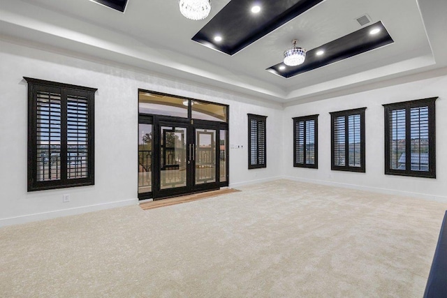 129 Cedar Dr, Horseshoe Bay, TX 78657 - carpeted empty room featuring a tray ceiling, a chandelier, baseboards, and recessed lighting