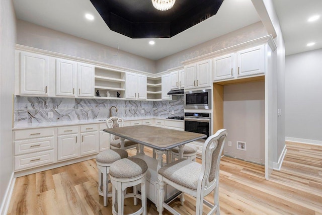 129 Cedar Dr, Horseshoe Bay, TX 78657 - kitchen with appliances with stainless steel finishes, open shelves, decorative backsplash, light wood-style flooring, and recessed lighting