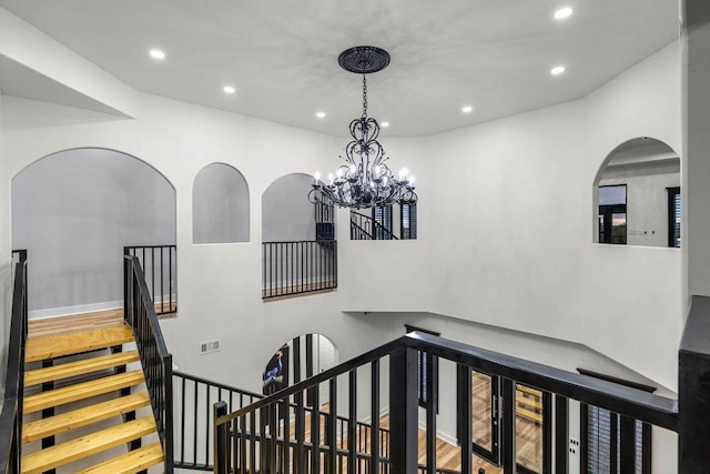 129 Cedar Dr, Horseshoe Bay, TX 78657 - stairway featuring recessed lighting, a chandelier, and arched walkways