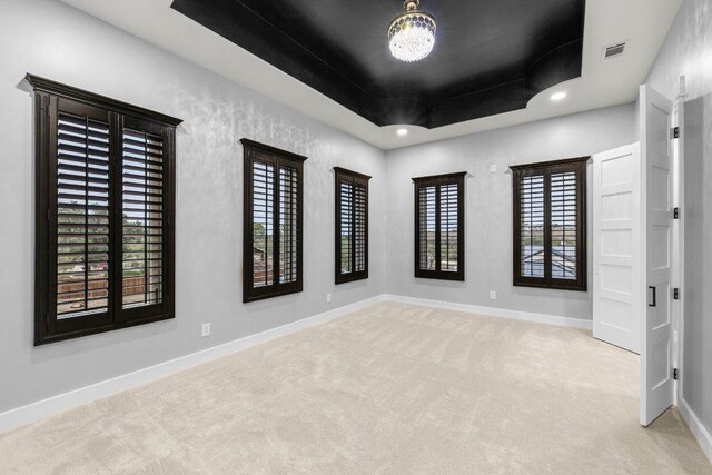 129 Cedar Dr, Horseshoe Bay, TX 78657 - carpeted empty room featuring baseboards, a tray ceiling, and recessed lighting