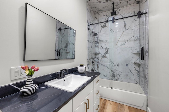 129 Cedar Dr, Horseshoe Bay, TX 78657 - full bath with vanity, wood finished floors, and a combined bath / shower with rainfall shower
