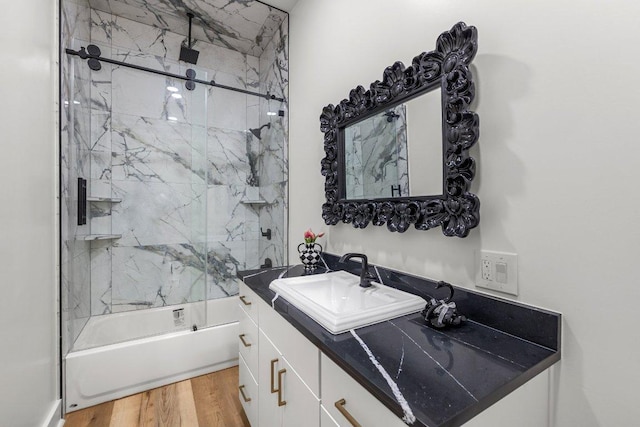 129 Cedar Dr, Horseshoe Bay, TX 78657 - bathroom featuring vanity, a combined bath / shower with rainfall shower, and wood finished floors