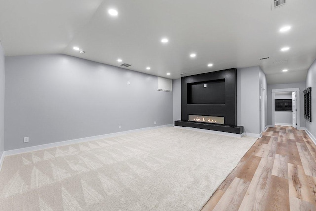 129 Cedar Dr, Horseshoe Bay, TX 78657 - unfurnished living room with recessed lighting, light wood finished floors, a large fireplace, baseboards, and lofted ceiling