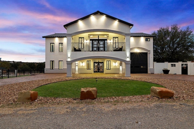129 Cedar Dr, Horseshoe Bay, TX 78657 - rear view of house featuring french doors, a balcony, curved driveway, stucco siding, and metal roof