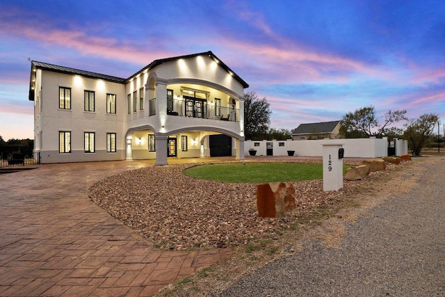129 Cedar Dr, Horseshoe Bay, TX 78657 - modern home with a balcony, curved driveway, and stucco siding