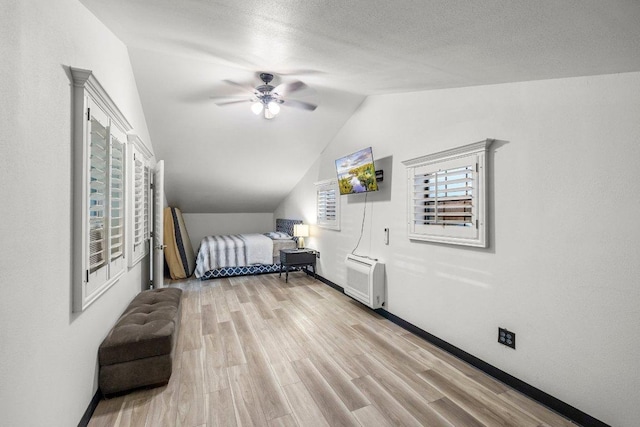129 Cedar Dr, Horseshoe Bay, TX 78657 - bedroom featuring lofted ceiling, wood finished floors, baseboards, and a ceiling fan