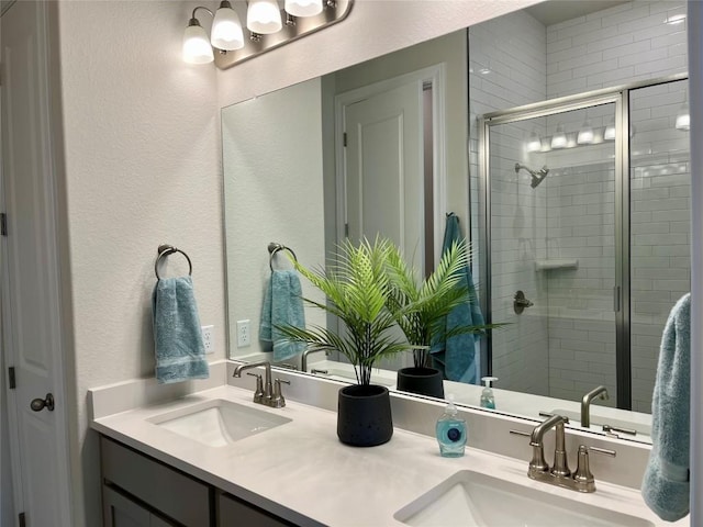 131 Courage Dr, Kyle, TX 78640 - full bath with double vanity, a shower stall, and a textured wall