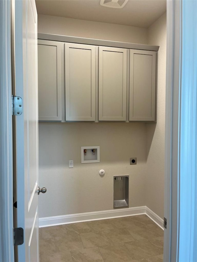 131 Courage Dr, Kyle, TX 78640 - laundry area with gas dryer hookup, hookup for an electric dryer, cabinet space, baseboards, and hookup for a washing machine