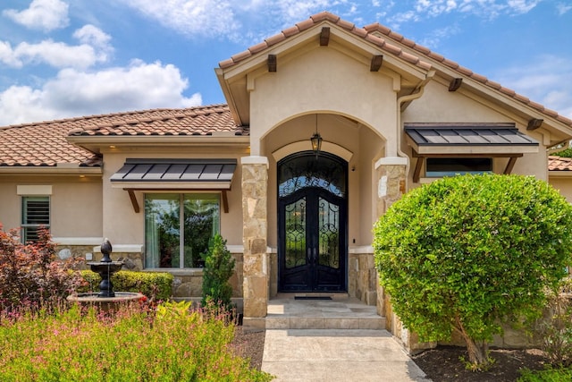 700 Zen Gardens Ter, Austin, TX 78732 - entrance to property featuring stone siding, stucco siding, and a tile roof