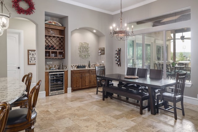 700 Zen Gardens Ter, Austin, TX 78732 - dining room with beverage cooler, wet bar, a chandelier, stone tile flooring, and crown molding