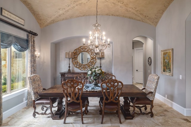 700 Zen Gardens Ter, Austin, TX 78732 - dining room featuring arched walkways, vaulted ceiling, a chandelier, and stone finish floors