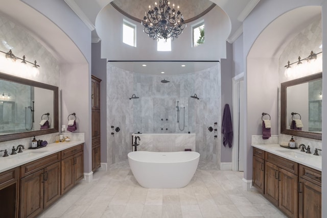 700 Zen Gardens Ter, Austin, TX 78732 - bathroom with a chandelier, a walk in shower, two vanities, a freestanding bath, and a towering ceiling