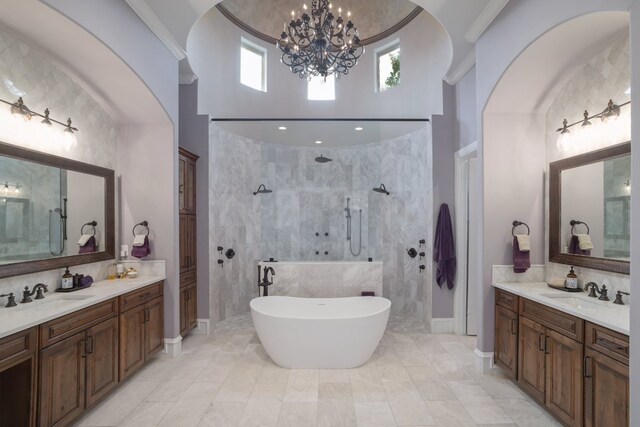 700 Zen Gardens Ter, Austin, TX 78732 - full bathroom with a chandelier, walk in shower, two vanities, a freestanding bath, and a high ceiling