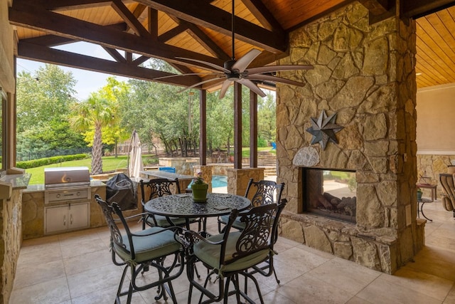 700 Zen Gardens Ter, Austin, TX 78732 - view of patio / terrace featuring a gazebo, exterior kitchen, outdoor dining area, ceiling fan, and an outdoor stone fireplace