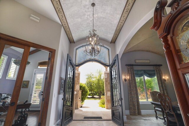 700 Zen Gardens Ter, Austin, TX 78732 - foyer entrance with a chandelier, vaulted ceiling, and arched walkways