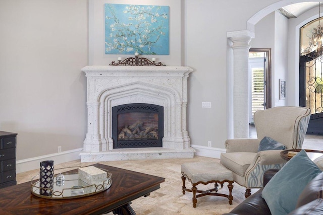 700 Zen Gardens Ter, Austin, TX 78732 - living room featuring arched walkways, a fireplace, and decorative columns