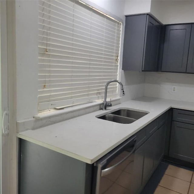 405 S Blue Ridge Parkway, Cedar Park, TX 78613 - kitchen featuring dishwasher, a sink, light countertops, light tile patterned flooring, and gray cabinets