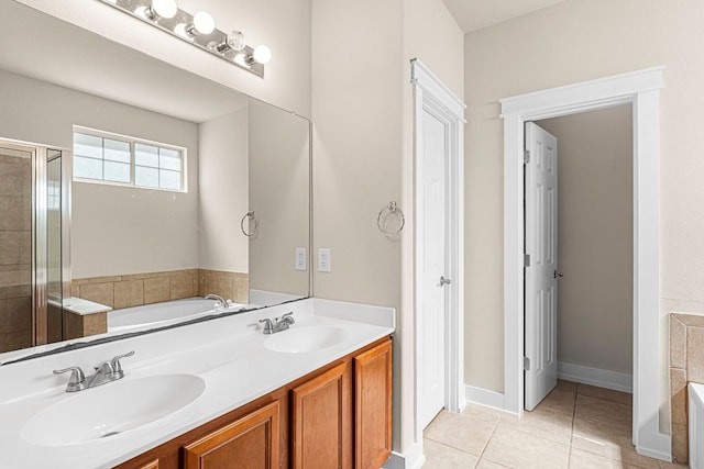 755 Hometown Pkwy, Kyle, TX 78640 - full bathroom featuring a garden tub, tile patterned flooring, double vanity, and a shower stall
