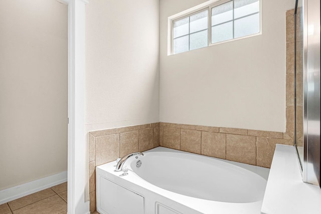 755 Hometown Pkwy, Kyle, TX 78640 - bathroom featuring a bath and tile patterned floors