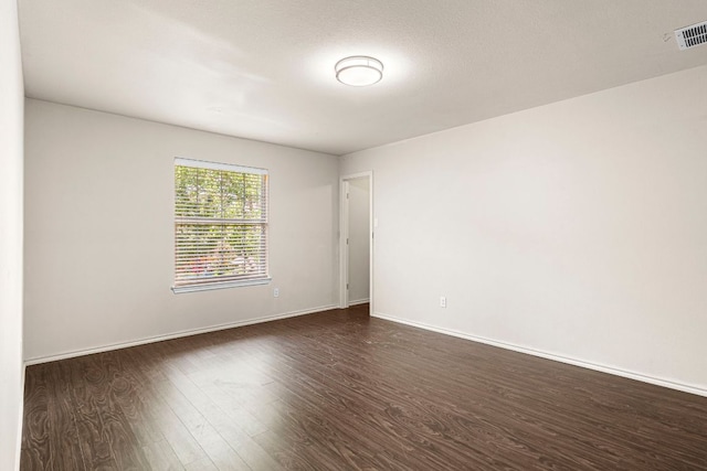 755 Hometown Pkwy, Kyle, TX 78640 - spare room featuring dark wood-type flooring and baseboards