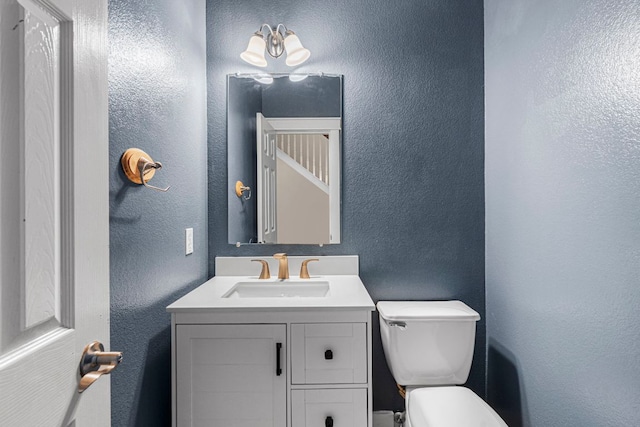 755 Hometown Pkwy, Kyle, TX 78640 - bathroom featuring toilet, vanity, and a textured wall