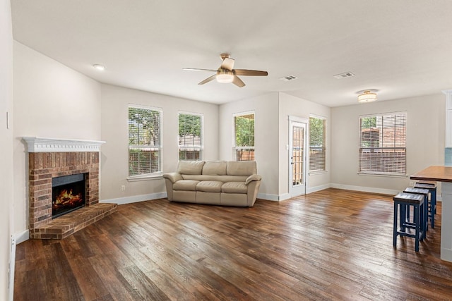 755 Hometown Pkwy, Kyle, TX 78640 - living room with ceiling fan, dark wood-style flooring, baseboards, and plenty of natural light