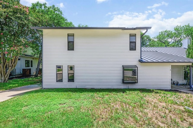 2814 Windsor Rd, Austin, TX 78703 - rear view of property featuring a standing seam roof, a yard, and metal roof