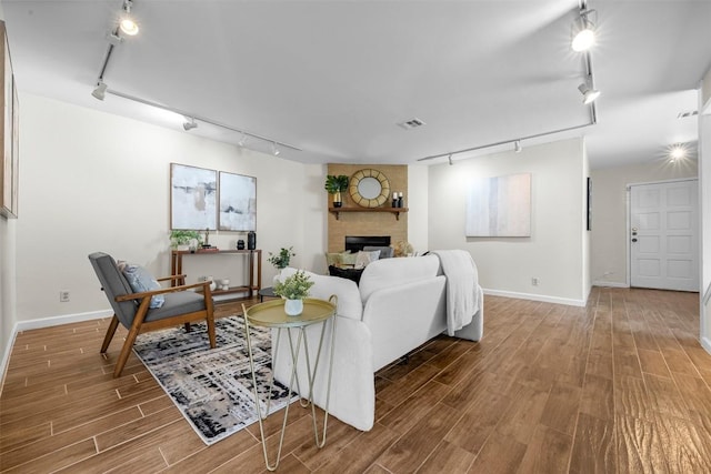 2814 Windsor Rd, Austin, TX 78703 - living room featuring track lighting, baseboards, and wood finished floors