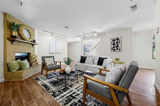 2814 Windsor Rd, Austin, TX 78703 - living area with track lighting, baseboards, wood finished floors, and stairs