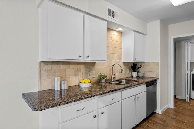 2814 Windsor Rd, Austin, TX 78703 - kitchen featuring stainless steel dishwasher, a sink, white cabinetry, backsplash, and dark stone counters