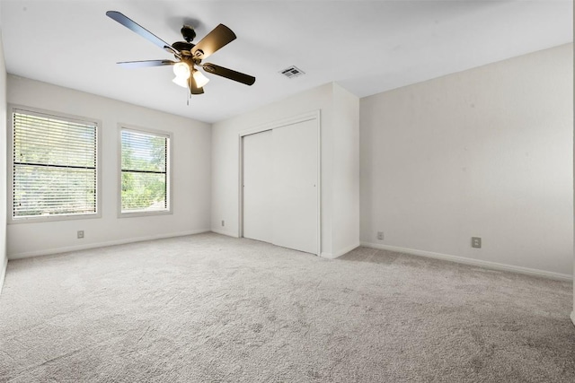 2814 Windsor Rd, Austin, TX 78703 - unfurnished bedroom featuring light colored carpet, baseboards, a closet, and a ceiling fan