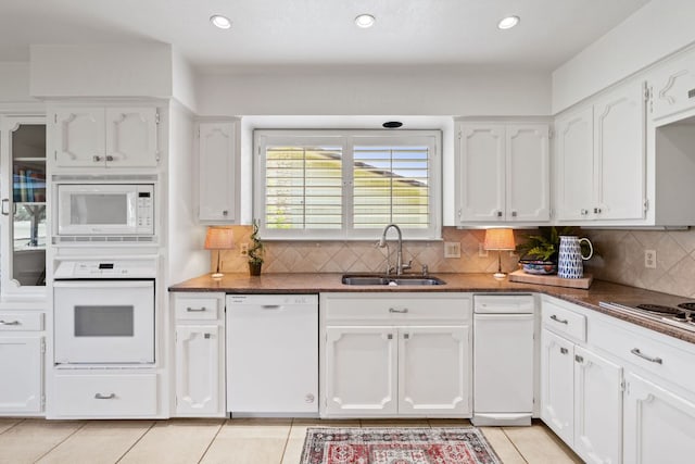 618 Hi Stirrup, Horseshoe Bay, TX 78657 - kitchen with white appliances, a sink, white cabinets, light tile patterned floors, and recessed lighting