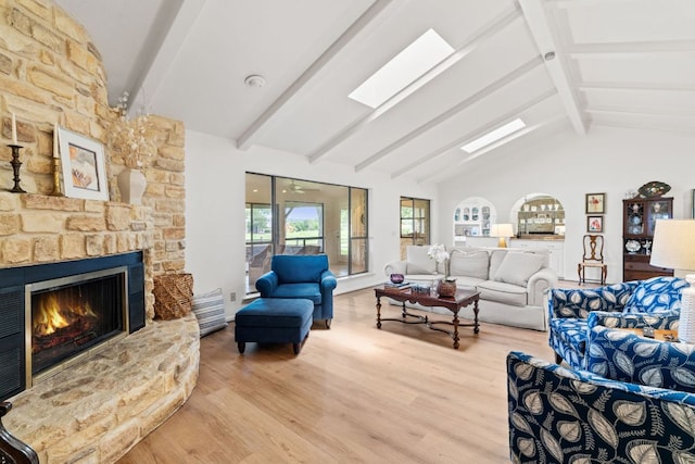 618 Hi Stirrup, Horseshoe Bay, TX 78657 - living room with wood finished floors, a stone fireplace, beam ceiling, and high vaulted ceiling