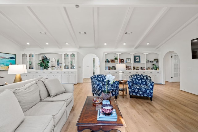 618 Hi Stirrup, Horseshoe Bay, TX 78657 - living area featuring arched walkways, light wood-style flooring, built in shelves, and baseboards