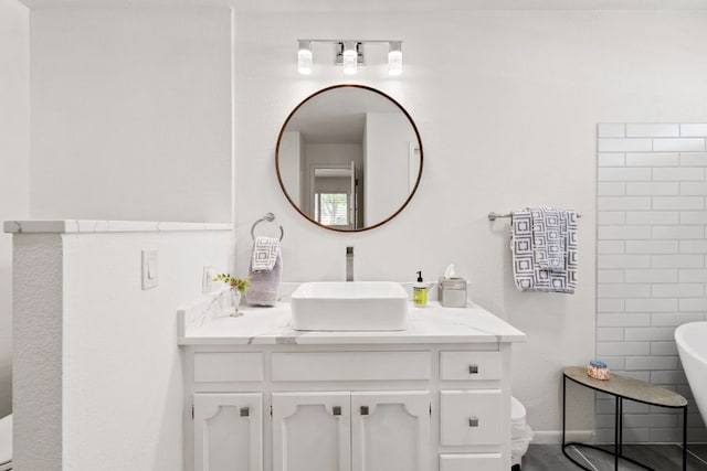 618 Hi Stirrup, Horseshoe Bay, TX 78657 - bathroom featuring vanity, a soaking tub, and toilet