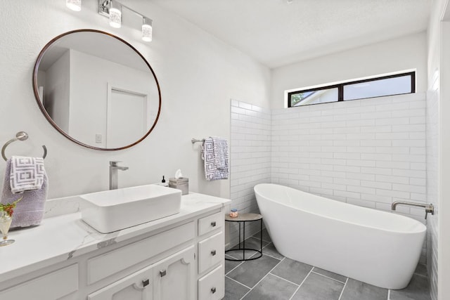 618 Hi Stirrup, Horseshoe Bay, TX 78657 - full bath featuring vanity, a freestanding tub, and tile patterned flooring