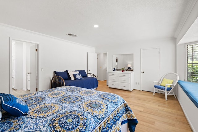 618 Hi Stirrup, Horseshoe Bay, TX 78657 - bedroom with crown molding, light wood-style floors, a textured ceiling, and recessed lighting